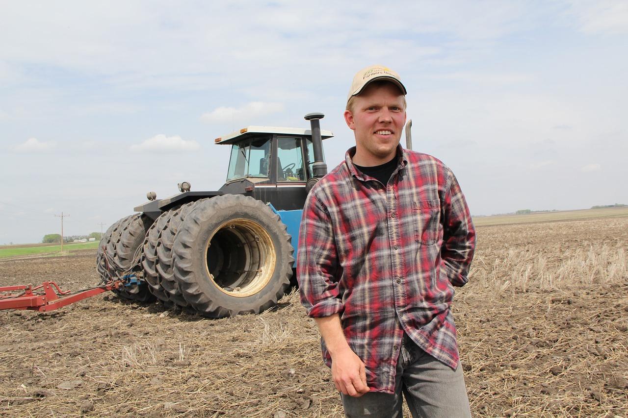 Young Farmer in front of Tractor