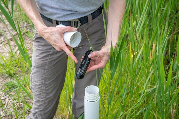 Researcher holding a HOBO Water Level Data Logger