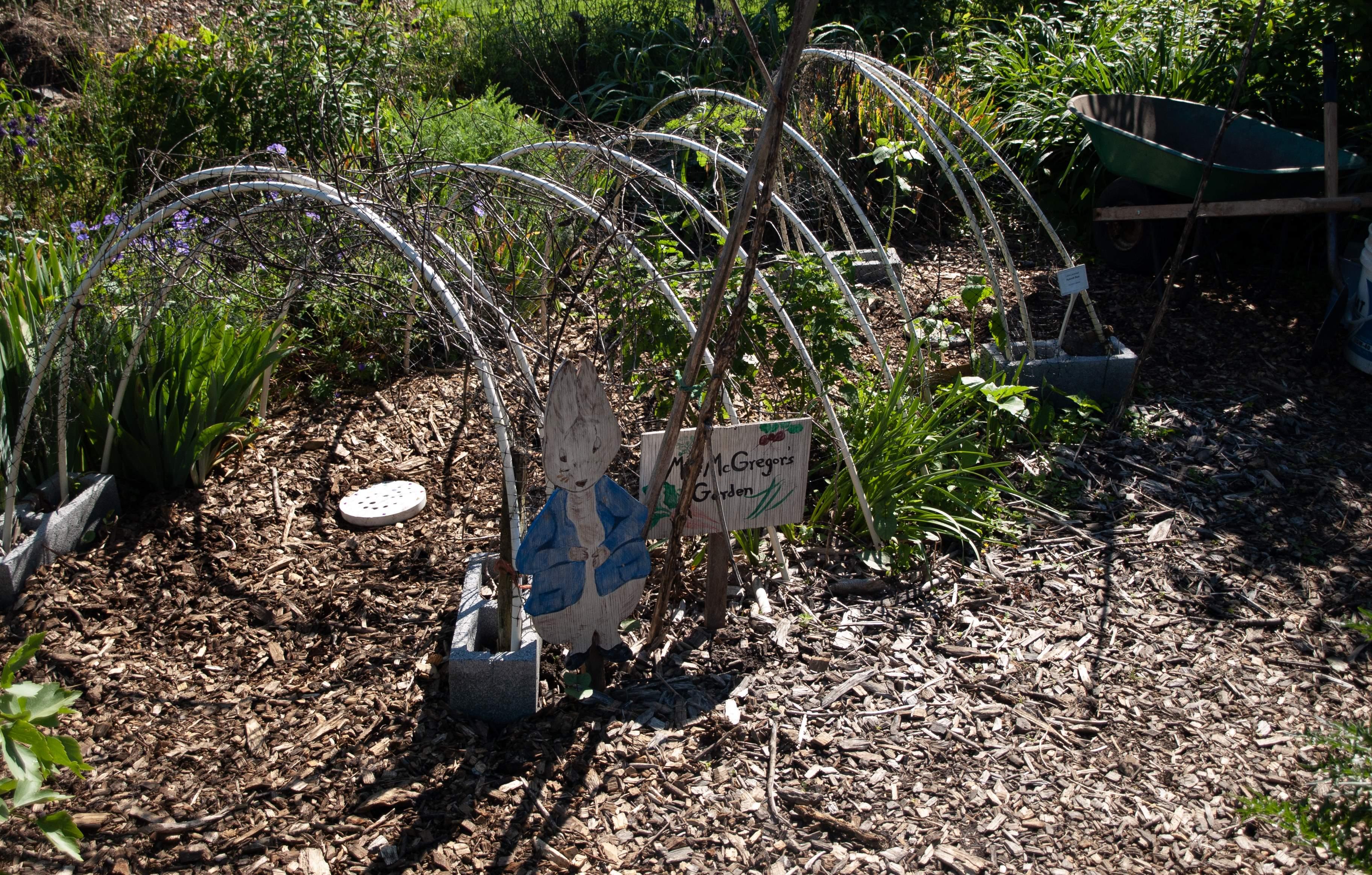 Children's garden featuring a tunnel and peter the rabbit cutout