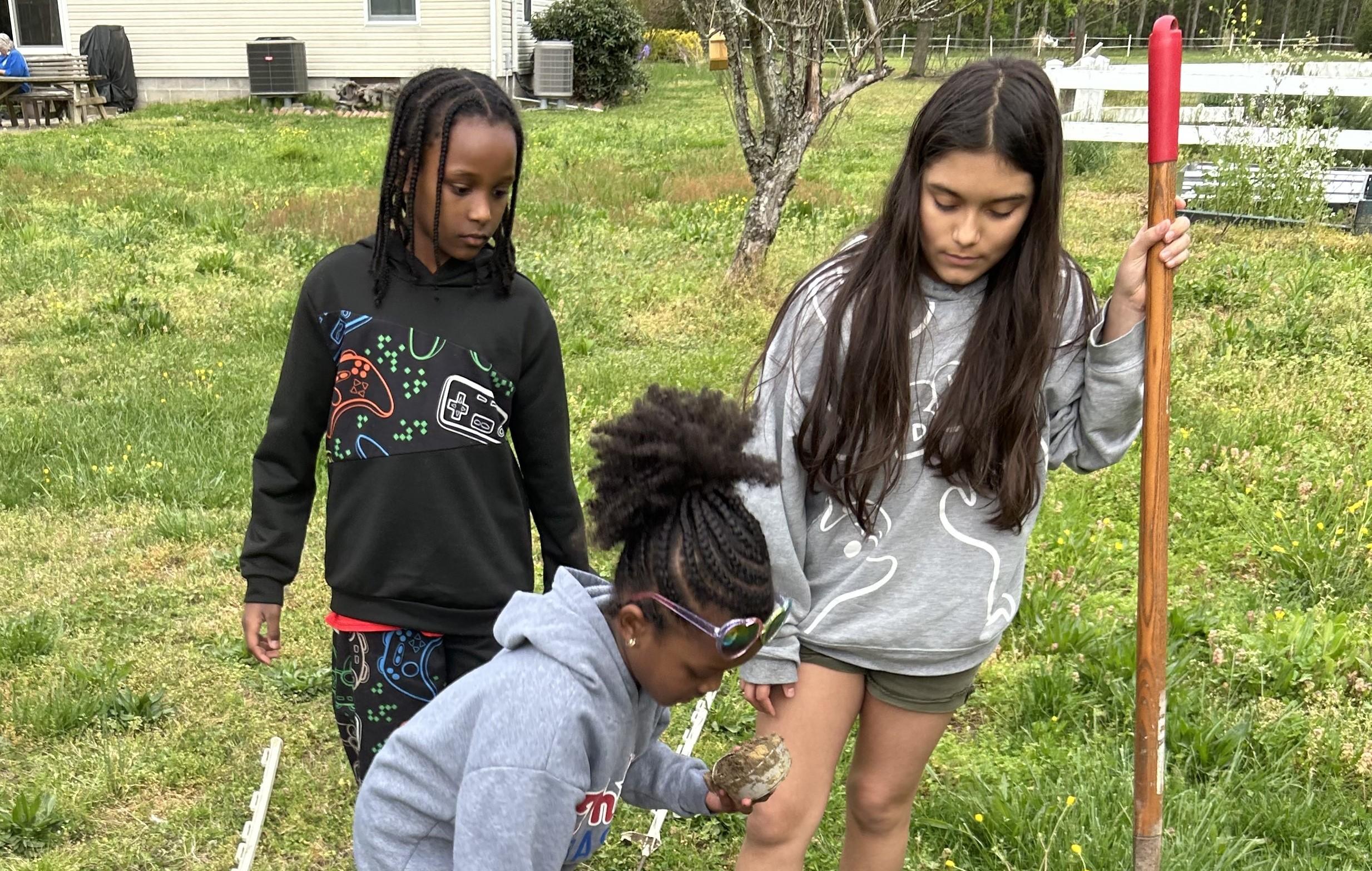 4-H members completing an environmental science project outdoors.