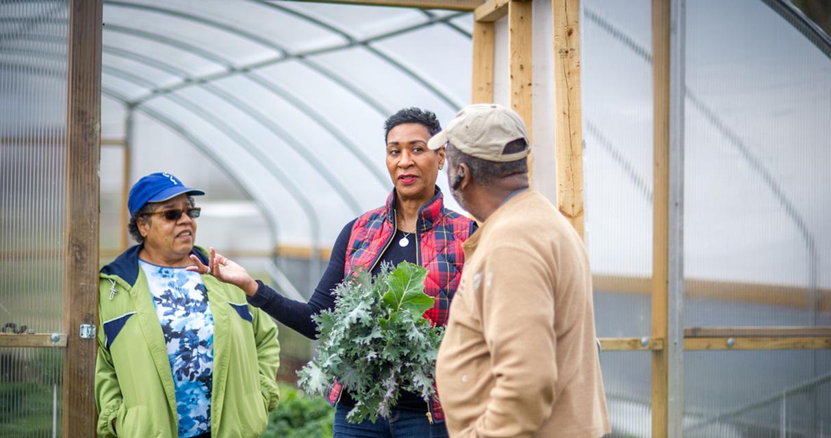 Manami Brown, Baltimore City Extension Director at Greener Garden Urban Farm in Baltimore with the Bell family