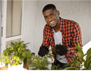 Picture of young man smiling with plants