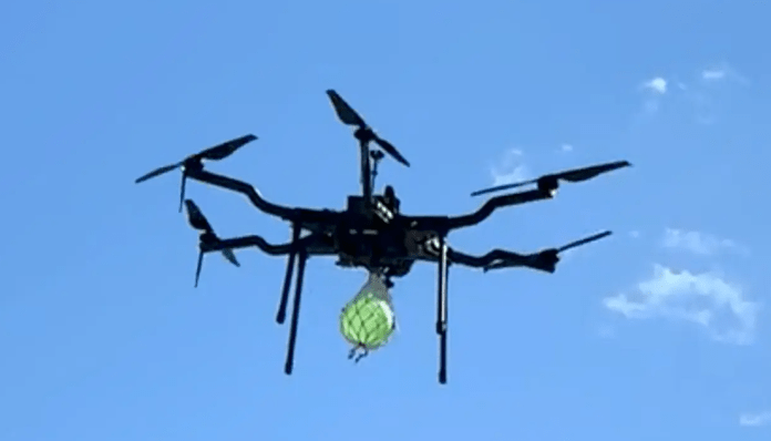 A drone with a water balloon suppression system flies during testing.  Photo courtesy of Crossfire