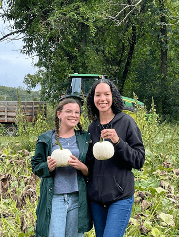 Two INAG123 students shown holding white pumkins