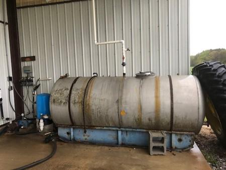 An industrial holding tank positioned on a concrete slab.