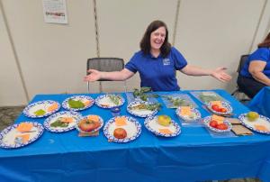 Woman in front of a table covered with plates of vegetables