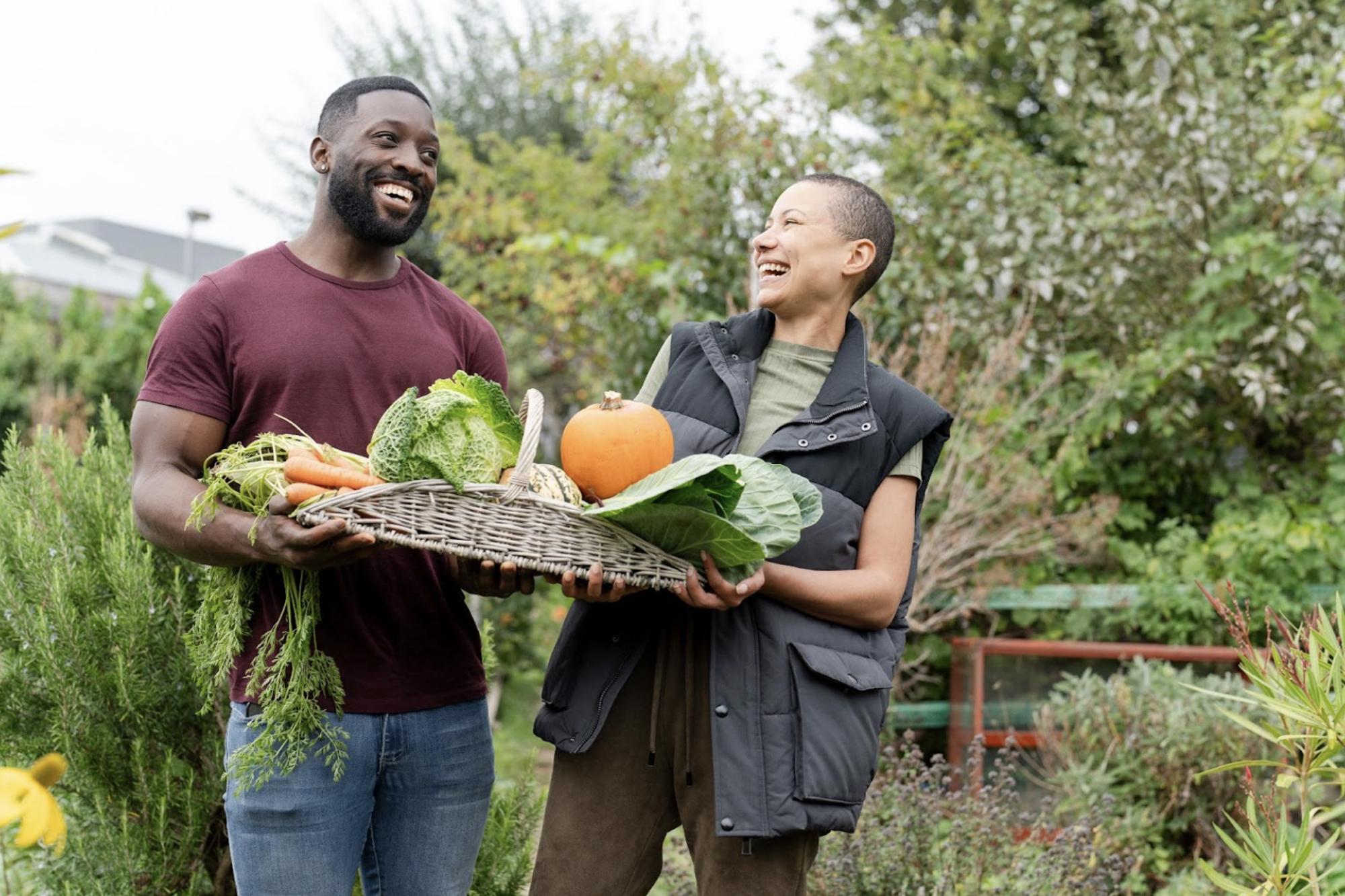 farmers holding a variety of produce