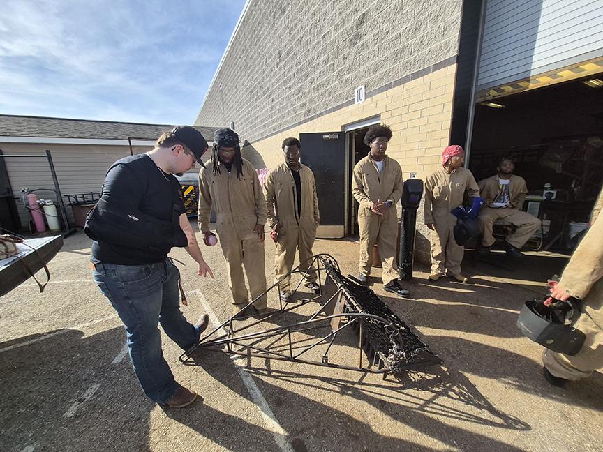 Students at North Point High School examine a standard aquaculture dredge.