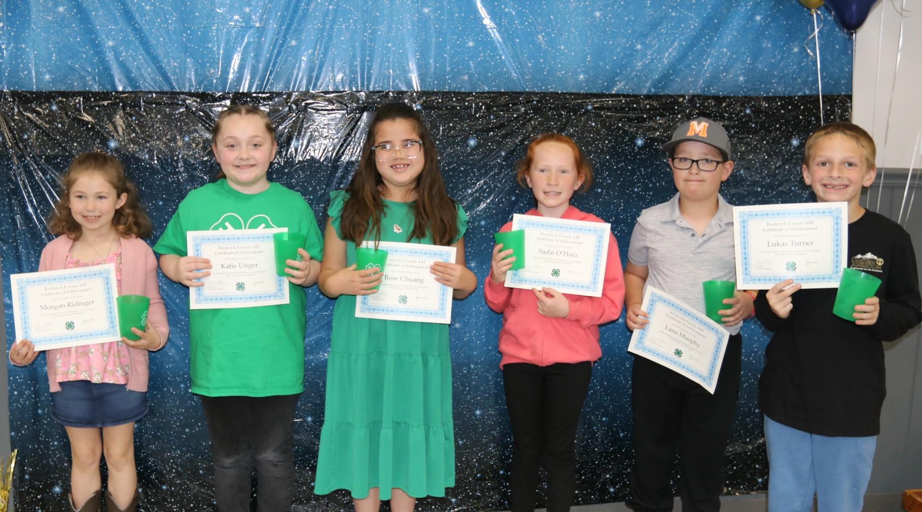 4-H members receiving awards at the annual awards ceremony