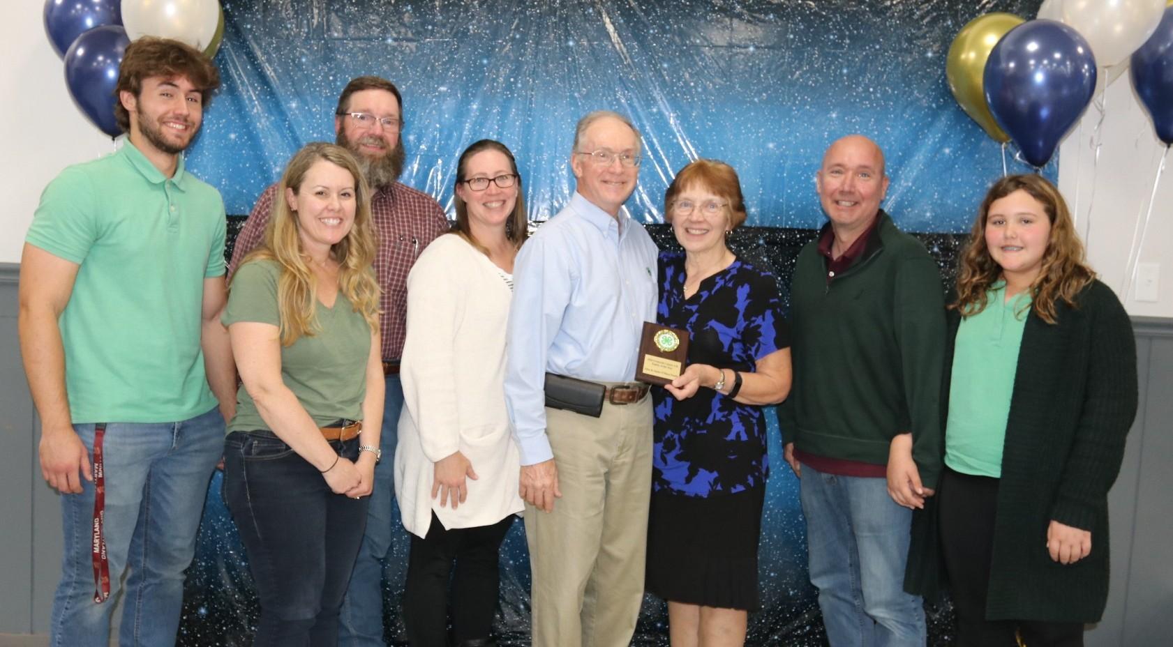 4-H family receiving an award at the annual awards ceremony