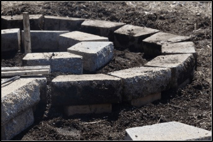 Concrete blocks placed in a circular direction on bare soil