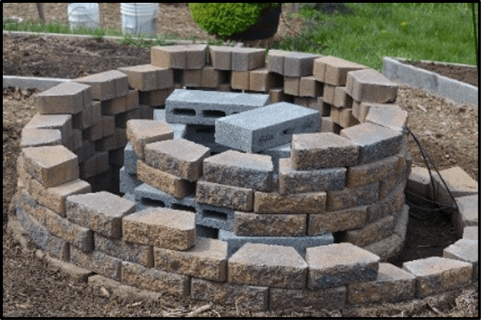 Several layers of concrete blocks placed in a circular direction with the center being the tallest